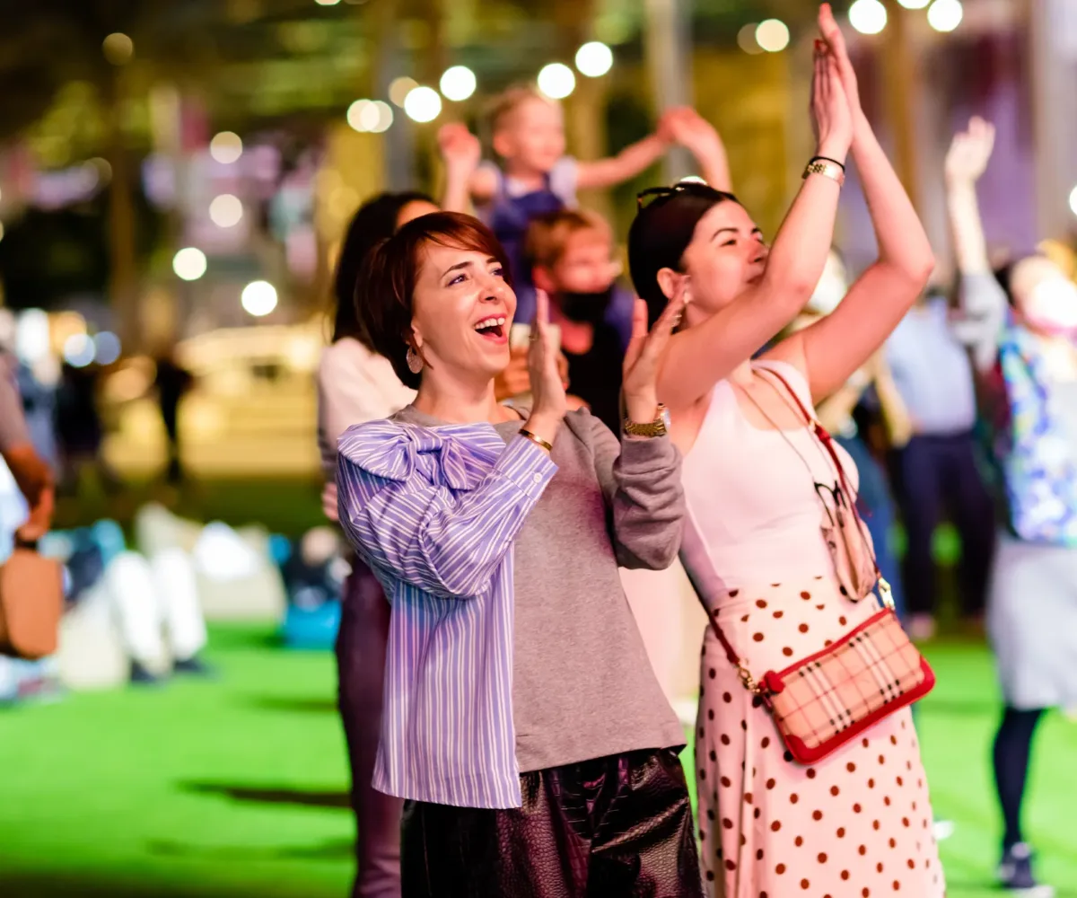 Audience clapping and smiling at performance Curated by The Association of Exiled Scots at Dubai World Expo