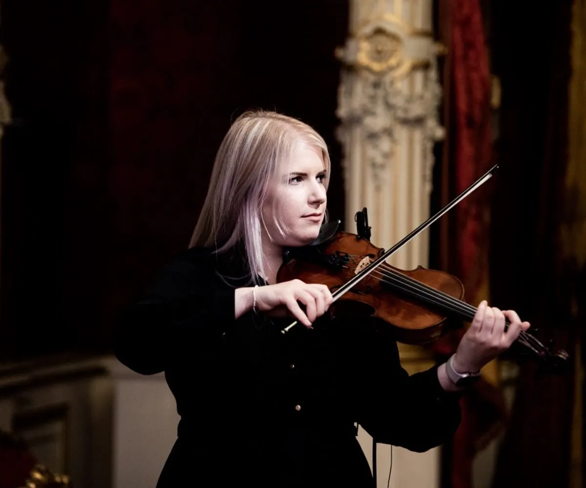 Scottish fiddle player performing live at a cultural brand activation event in Paris, France, curated by The Curators of Exiled Scots. Set within a historic diplomatic residence, this bespoke musical performance was designed to highlight Scottish heritage and talent for an audience of diplomats, international partners, and luxury brands. A powerful example of soft power and high-end Scottish entertainment for global audiences.