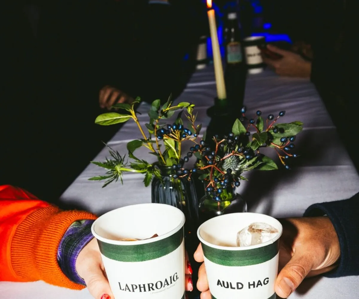 Branded Laphroaig and Auld Hag whisky cups raised in a toast at Auld Hag’s immersive Burns Night event in London, curated by The Curators of Exiled Scots. Set on a candlelit table dressed with Scottish thistles and tartan, this premium brand activation blended contemporary Scottish hospitality, storytelling and live performance, creating a memorable experience for guests and global partners.